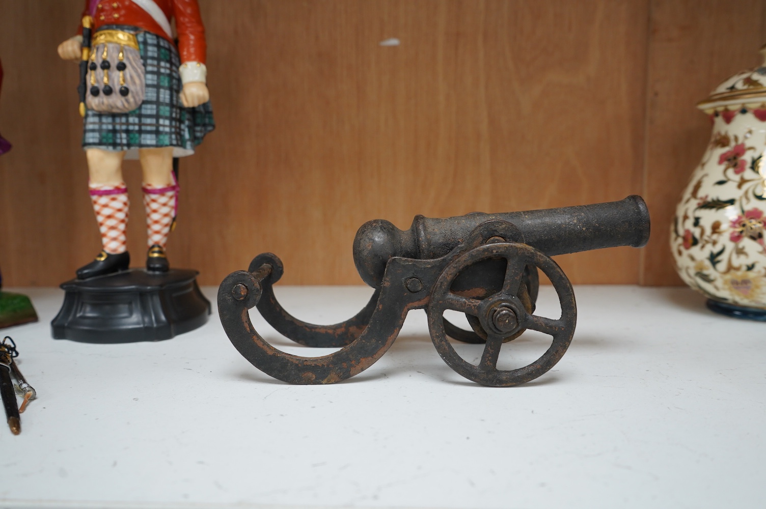 A miniature cast iron table canon, 19cm in length. Condition - fair